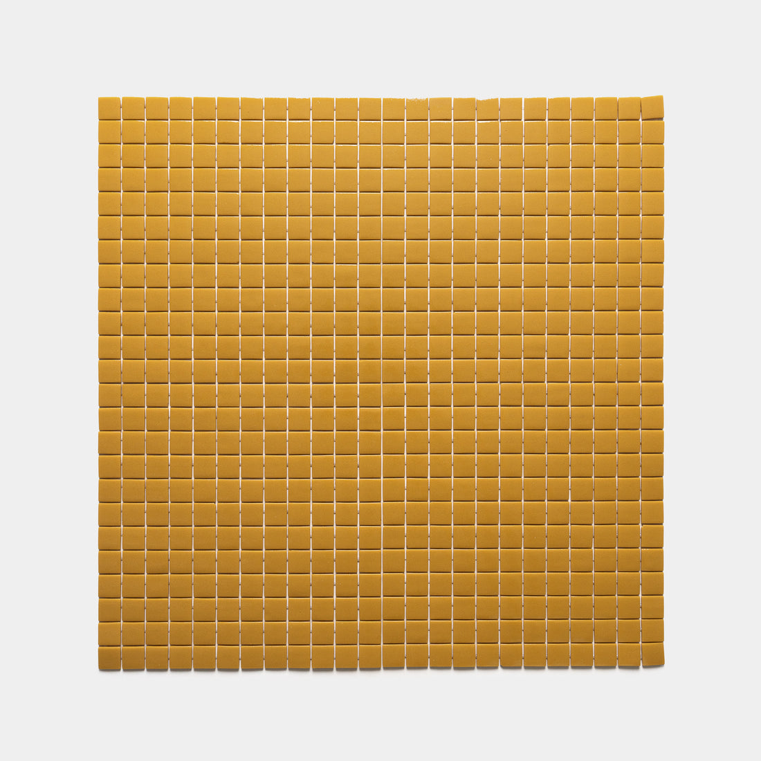 Zia Tile’s Rye 1x1 features a grid of small, square, yellowish-brown tiles arranged in even rows and columns on a white background.