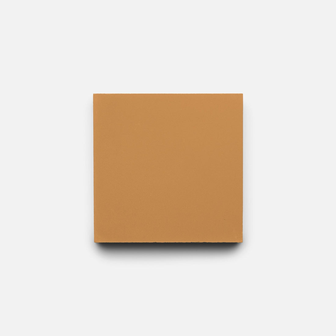 A single Saddle 4x4 tile by Zia Tile, square and tan-colored with smooth edges and a matte finish, is centered on a plain white background.