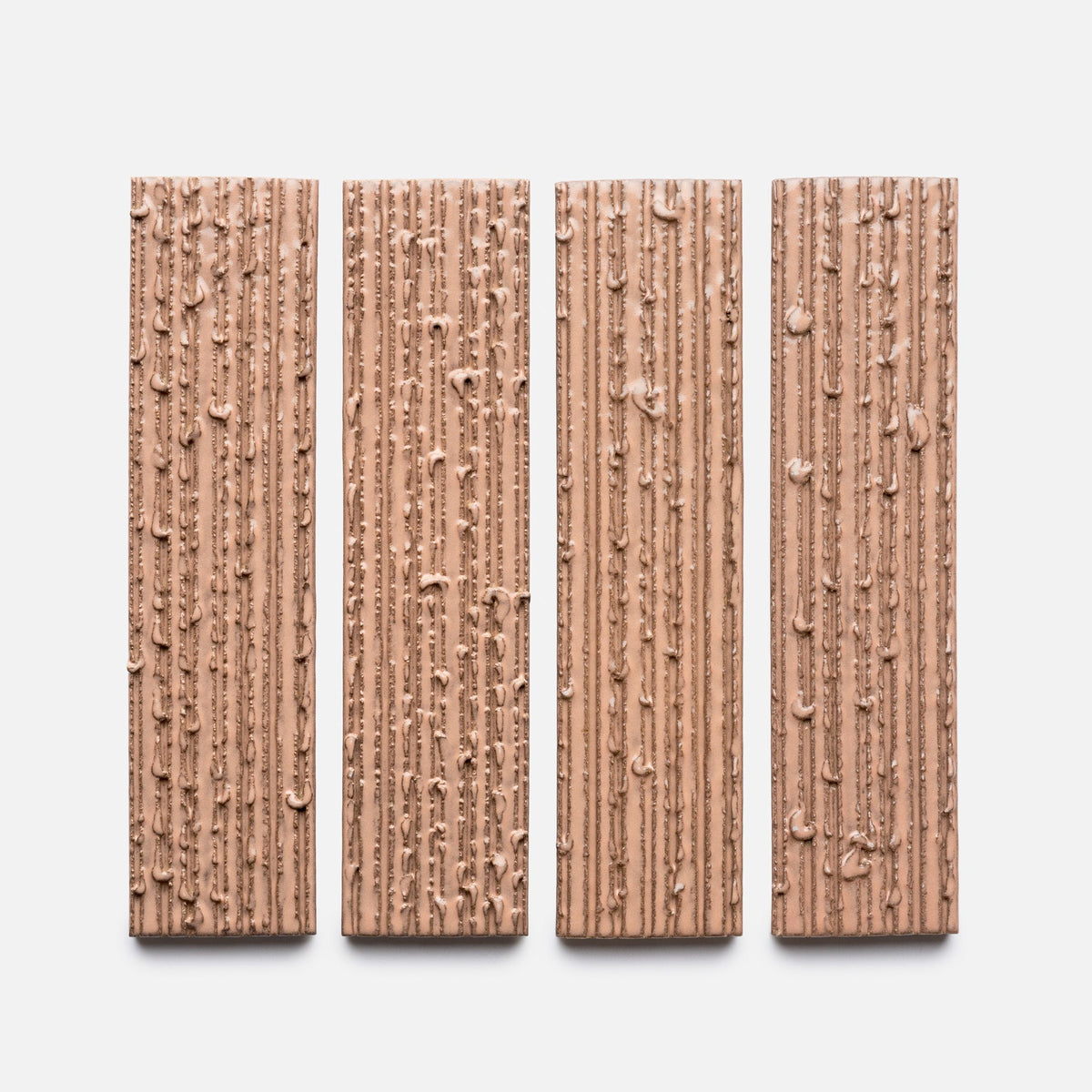 Four Sakura + Furrowed, Sample bars by Zia Tile are displayed vertically side by side. Each bar features a textured surface with vertical ridges and small clusters, all set against a plain white background.