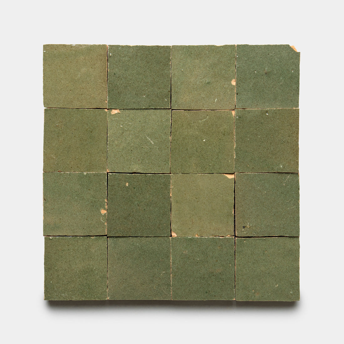 Sixteen Savanna 2x2 tiles by Zia Tile, arranged in a square grid with green hues, slight wear, minor chips, and color variations displayed on a light background.