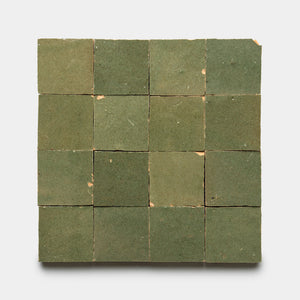 Sixteen Savanna 2x2 tiles by Zia Tile, arranged in a square grid with green hues, slight wear, minor chips, and color variations displayed on a light background.