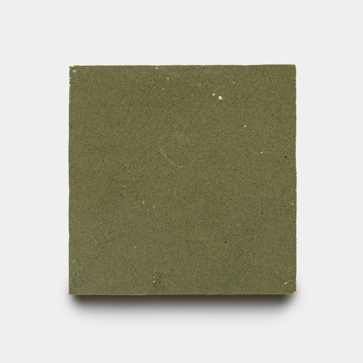 A single Savanna 4x4 tile by Zia Tile in olive green, featuring a matte finish and subtle surface imperfections, is displayed on a plain white background.