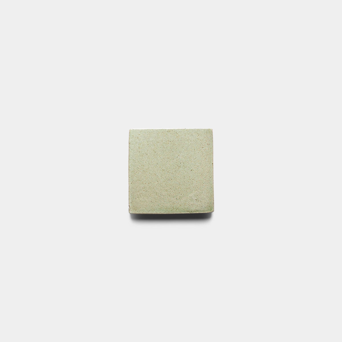A single Sayulita 4x4 Square sample tile by Zia Tile, light beige and handmade with a smooth, slightly textured surface, is centered on a plain white background.