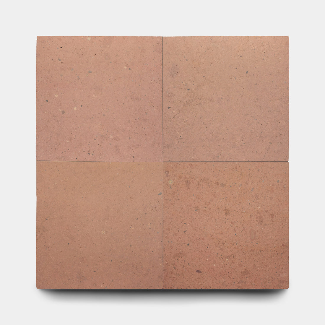 Four square Sedona 24x24 tiles by Zia Tile, in reddish-brown Cantera stone, are arranged two-by-two on a white background, showcasing a smooth surface with subtle natural speckling and Mexican Cantera texture.