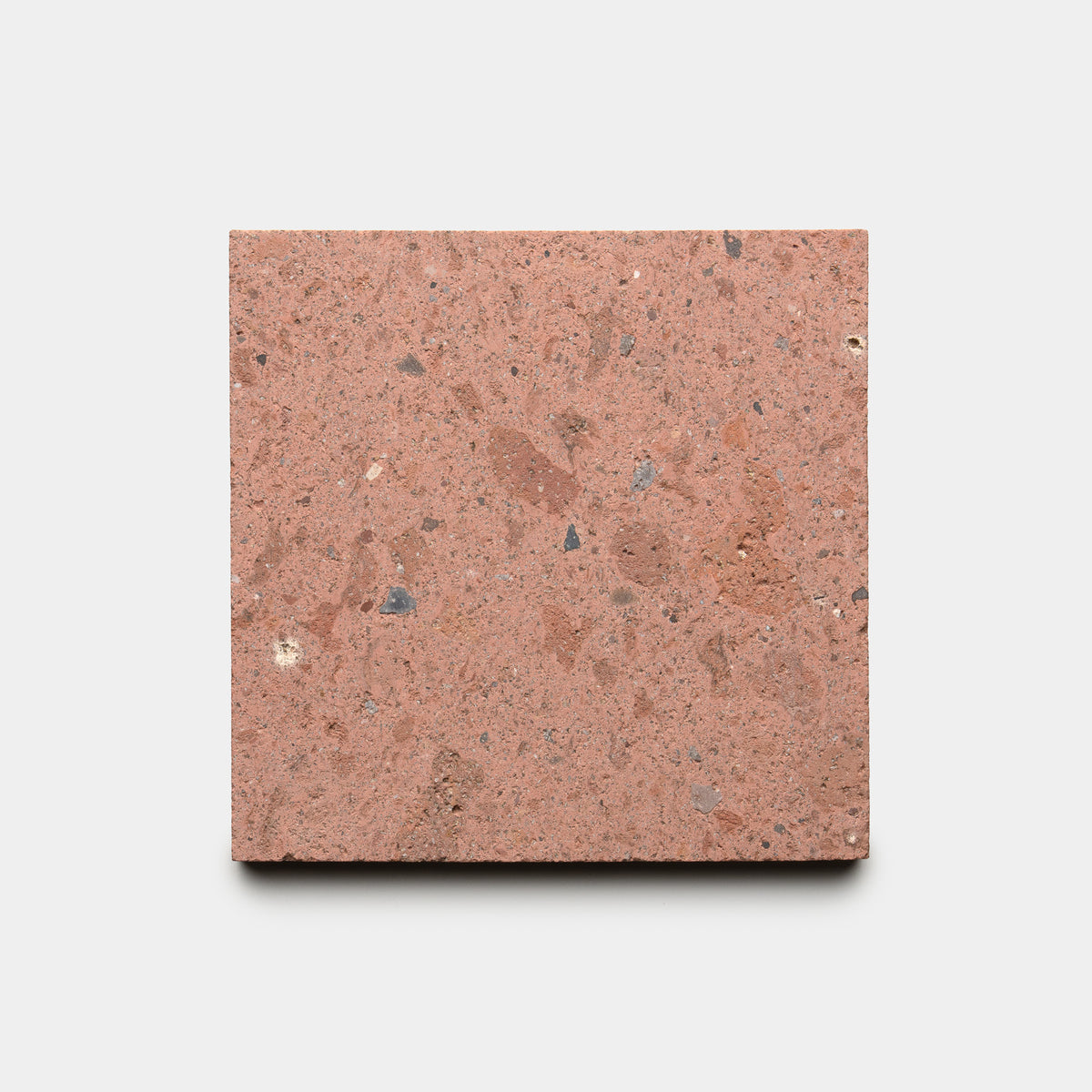 The Sedona 6x6 by Zia Tile is a square, reddish-brown terrazzo tile with small gray and tan stone chips, shown on a plain white background.