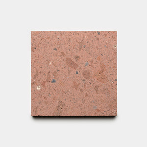 The Sedona 6x6 by Zia Tile is a square, reddish-brown terrazzo tile with small gray and tan stone chips, shown on a plain white background.
