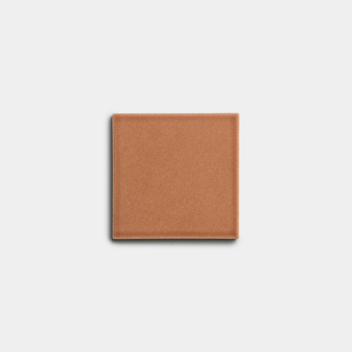 A single Sepia 4x4 ceramic tile by Zia Tile, square and reddish-brown, centered on a plain white background.