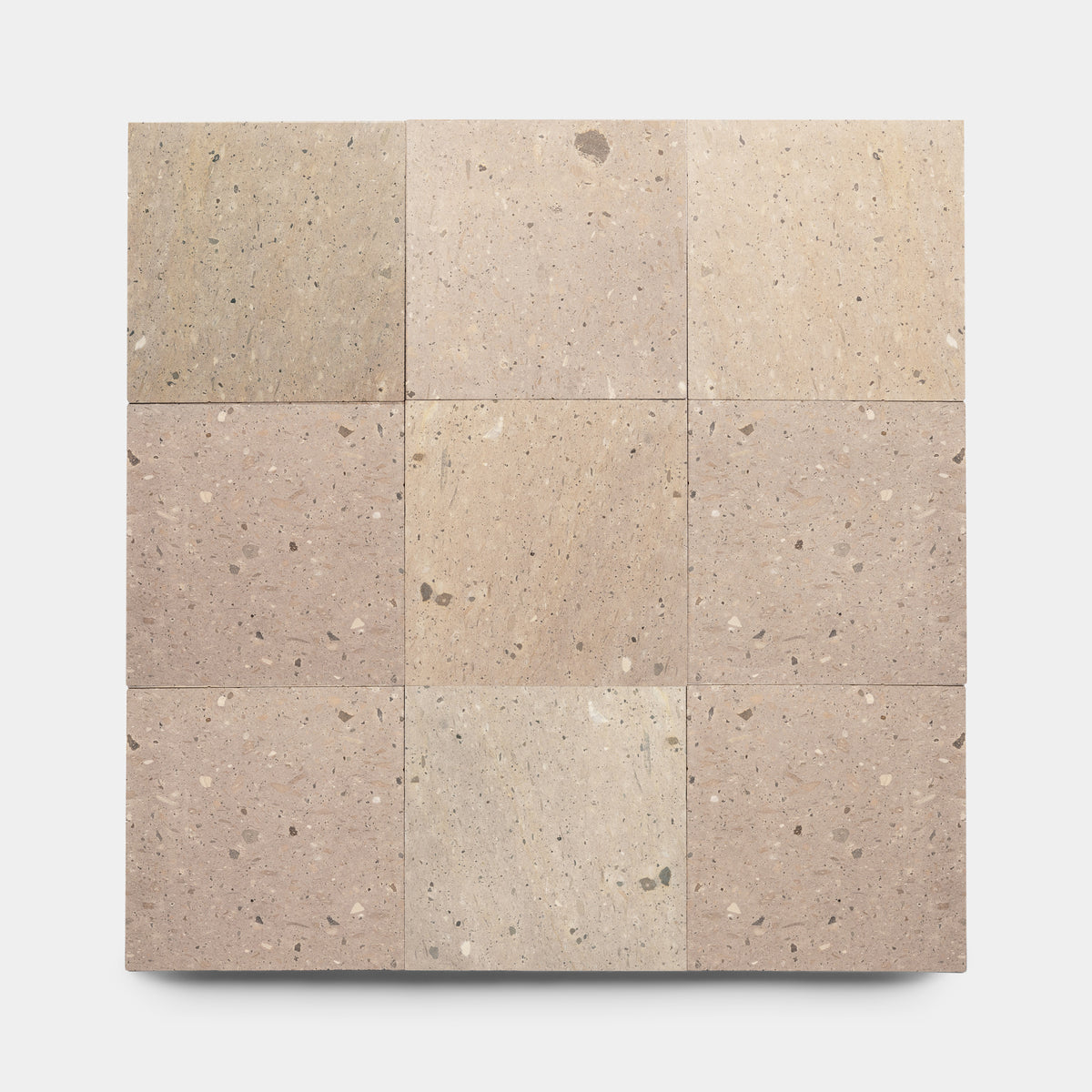 A top-down view shows nine Zia Tile Sierra 12x12 square tiles in a 3x3 grid, featuring lightly speckled beige Mexican Cantera stone, displayed on a plain white background.