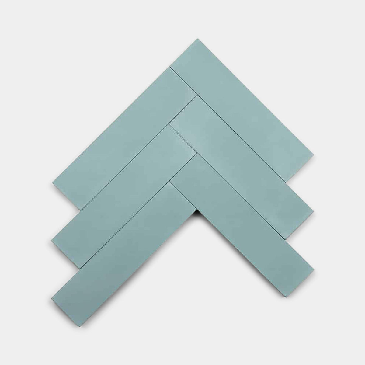 Six rectangular Sky Blue 2x8 cement tile samples by vendor-unknown are arranged in a chevron or herringbone pattern on a white background, forming a zigzag or arrow-like shape.