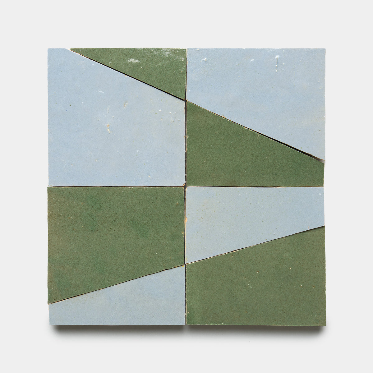 Atlas 3 by Zia Tile features four square tiles in a grid, each split diagonally into green and light blue triangles, creating an alternating geometric pattern on a crisp white background.