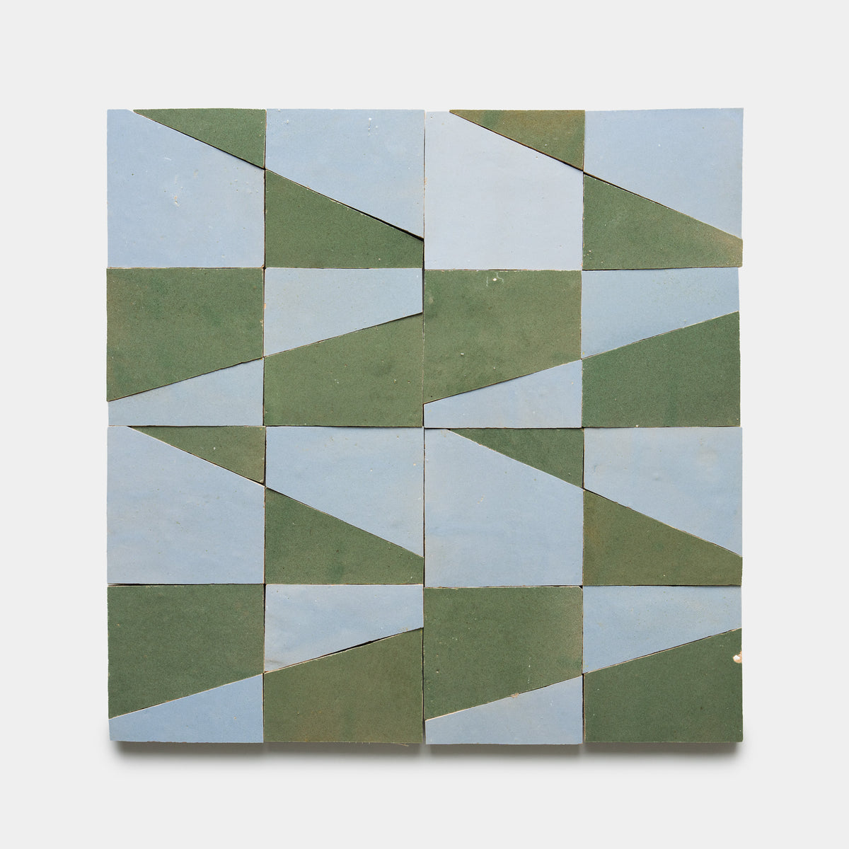 The Zia Tile Atlas 3 features sixteen square tiles in a 4x4 grid, each split diagonally into green and light blue triangles for a bold geometric look on a white background.