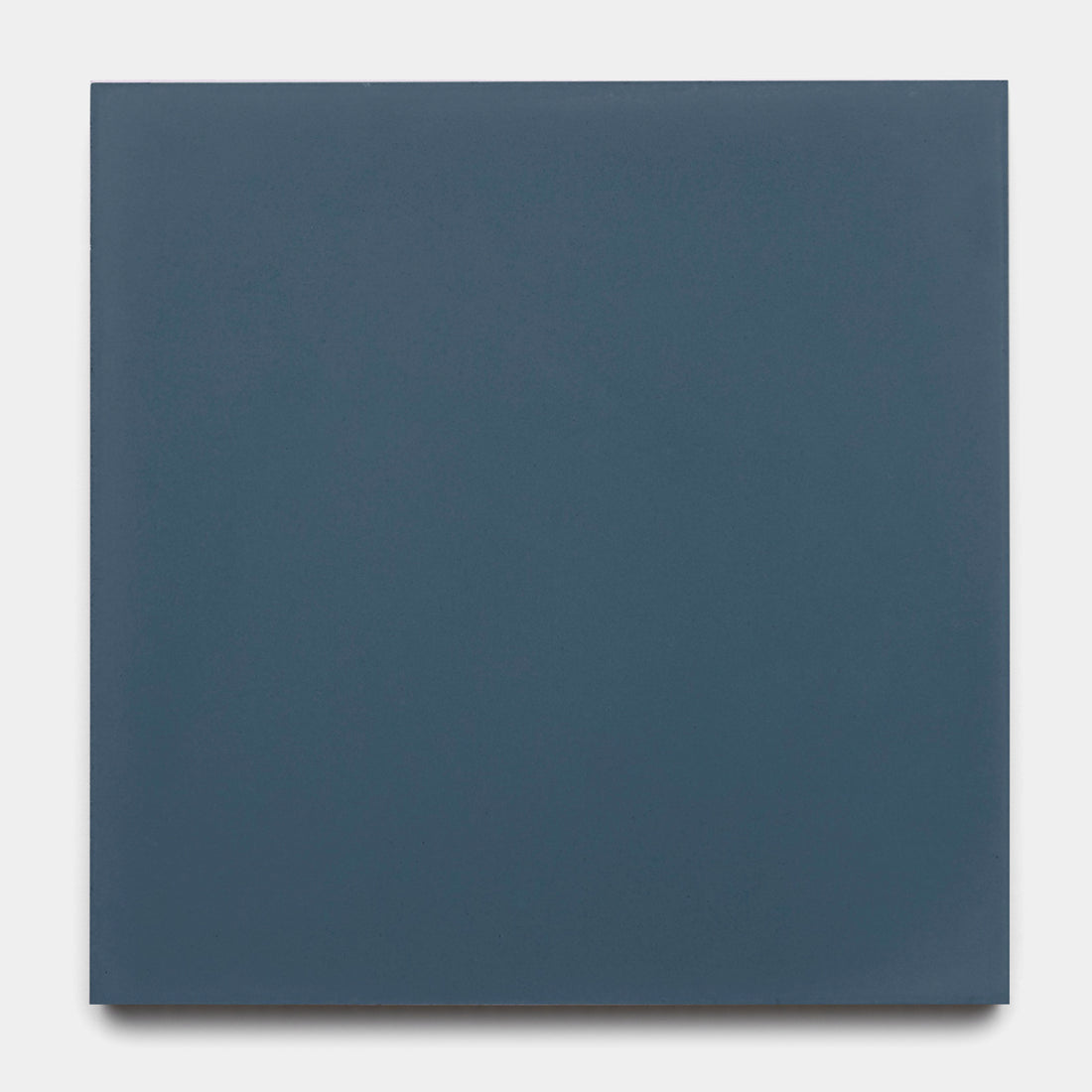 The Slate 8x8 by vendor-unknown is a matte, dark blue-gray solid-colored cement tile, shown here set against a light gray background.