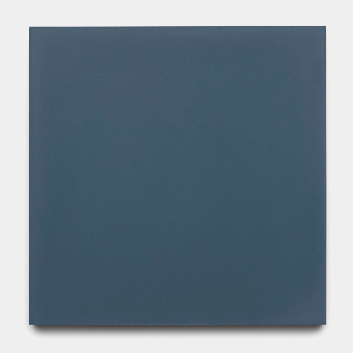 The Slate 8x8 by vendor-unknown is a matte, dark blue-gray solid-colored cement tile, shown here set against a light gray background.