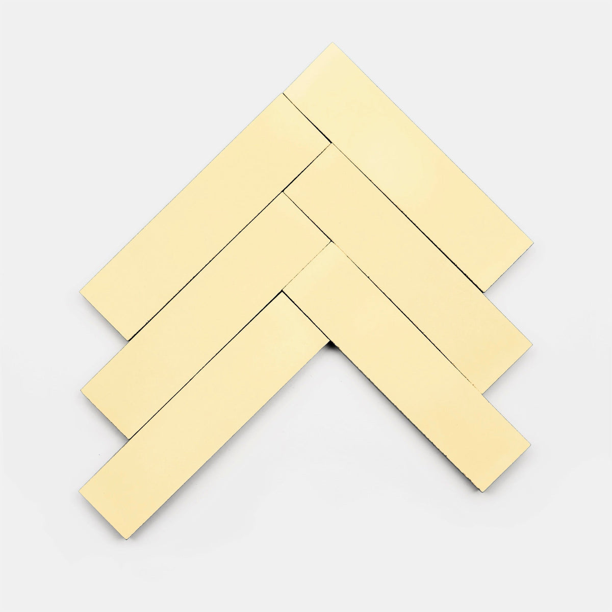 Five rectangular, cream-colored Solar 2x8 sample tiles from vendor-unknown are arranged in a herringbone pattern on a plain white background.