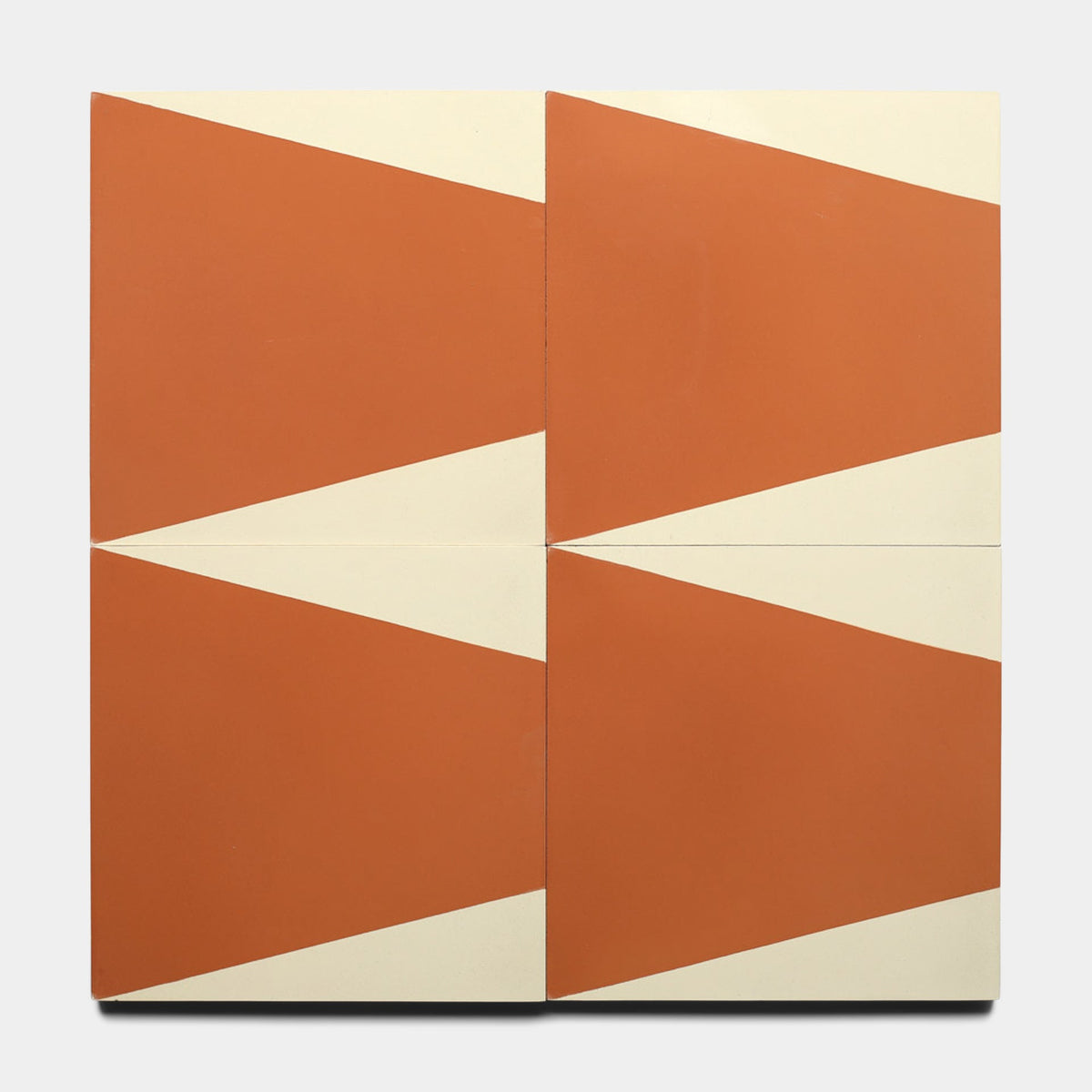 Four Sparrow Rust 8x8 samples from Zia Tile, each featuring a diagonal rust design on cream, form a bold geometric pattern when arranged in a grid.