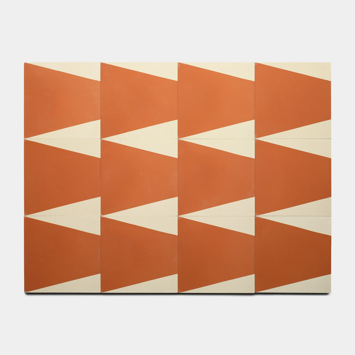 Featuring bold triangles in red-orange and cream, Zia Tile's Sparrow Rust 8x8 Sample creates a repeating zigzag pattern with an eye-catching geometric design.