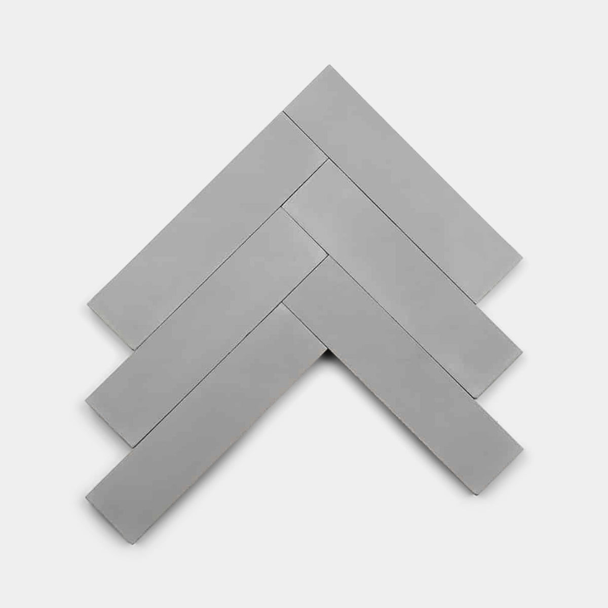 Five Steel 4x4 sample tiles from Zia Tile are arranged in a classic herringbone pattern on a white background.