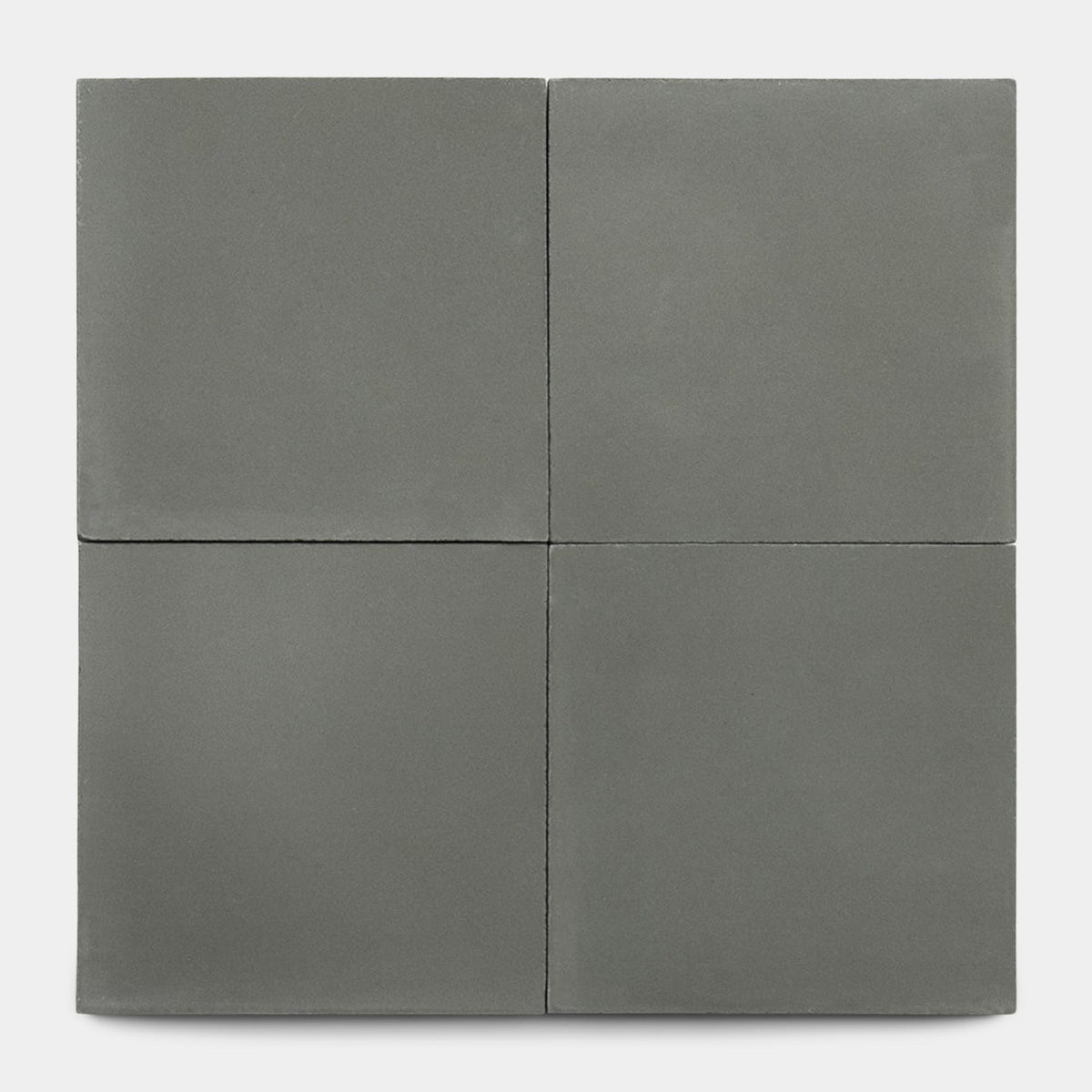Four square, matte gray tiles from Zia Tile's Rust 8x8 Sample are arranged in a 2x2 grid on a white background, showcasing smooth surfaces and fine lines for a sleek, modern look.