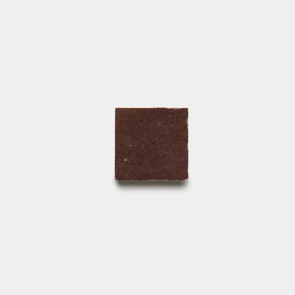 A single Sumac 2x2 tile by Zia Tile is centered on a plain white background, casting a faint shadow below.