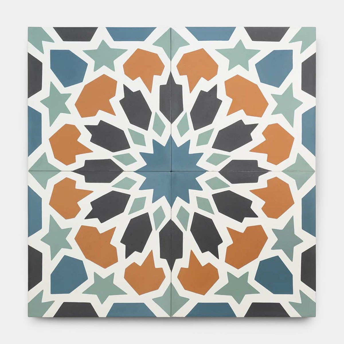 The Tangier 8x8 sample by vendor-unknown features a symmetrical starburst geometric tile pattern in blue, teal, orange, black, and white, inspired by handmade cement tile artistry.