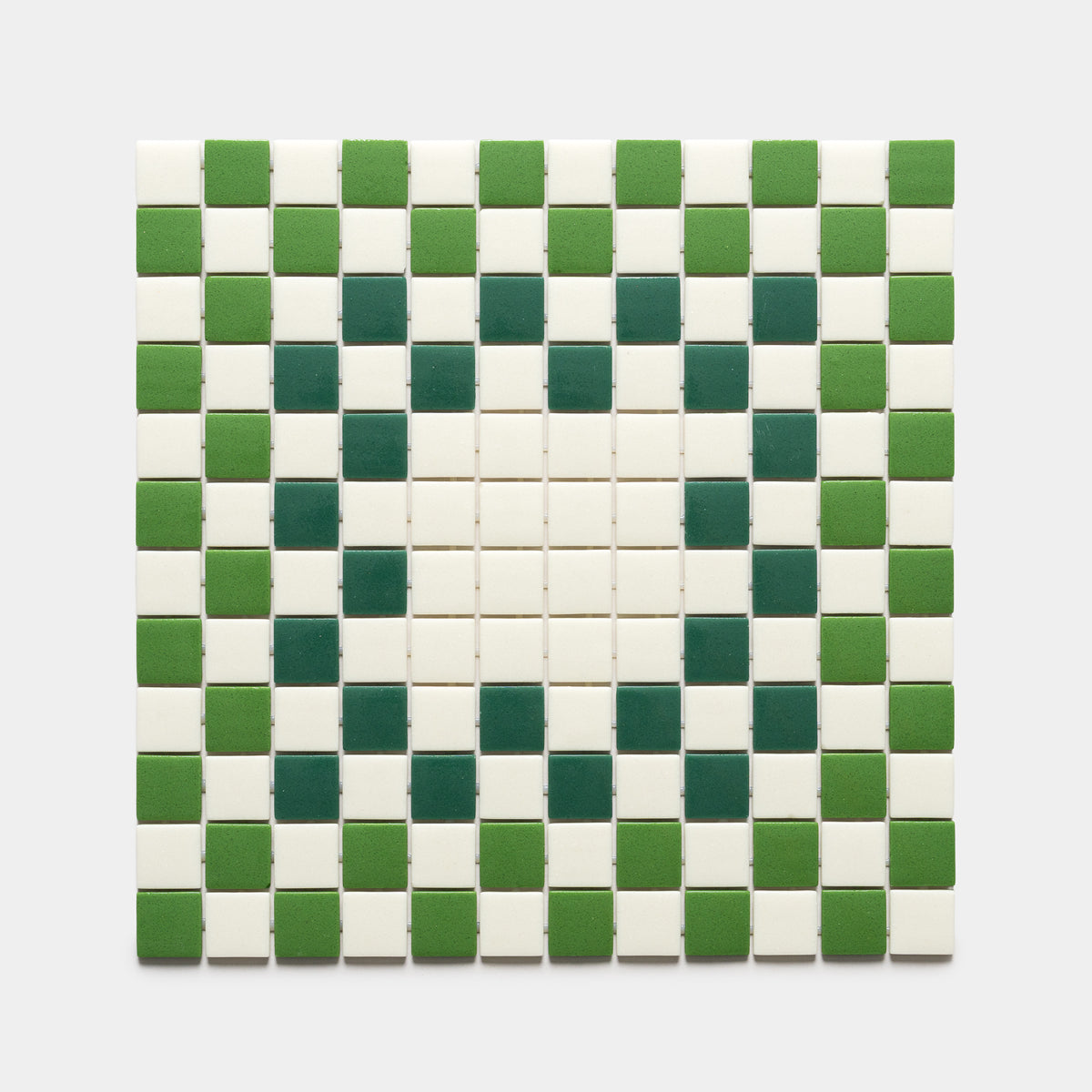 The Tesserae Milk + Clover + Jasper sample by Zia Tile features a square grid of tiles in alternating green and white, forming a central diamond motif on a plain light gray background.