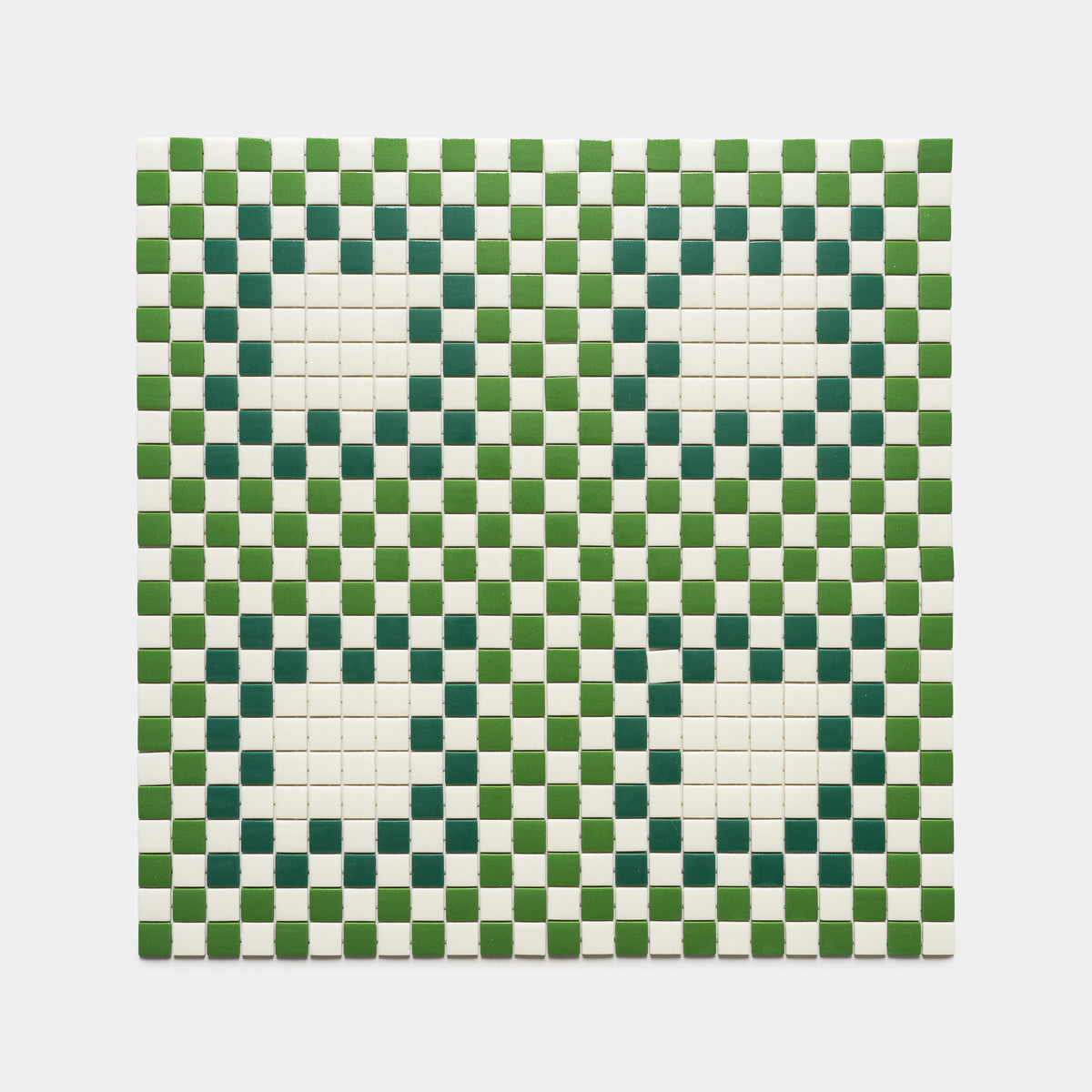 The Tesserae Milk + Clover + Jasper by Zia Tile is a square tile mosaic with a green and white checkerboard pattern, featuring four large white circles outlined by dark green tiles, evenly spaced in the grid.