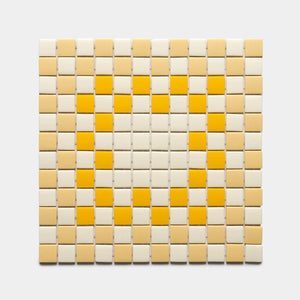 A grid of Zia Tile’s Tesserae Sesame, Buttercup, and Canary tiles forms a heart shape in yellow shades on a light background. Sample available.