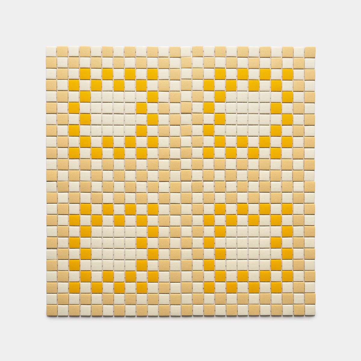 The Tesserae Sesame + Buttercup + Canary tile by Zia Tile features a square mosaic with a checkerboard pattern in beige, yellow, and white, forming four yellow-outlined circles filled with white tiles.