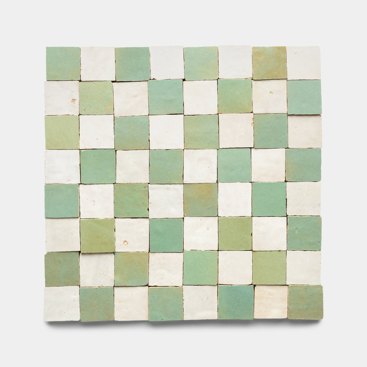 A checkerboard pattern of Zia Tile’s Tidepool + Casablanca Checkerboard ceramic tiles displayed against a plain white background.
