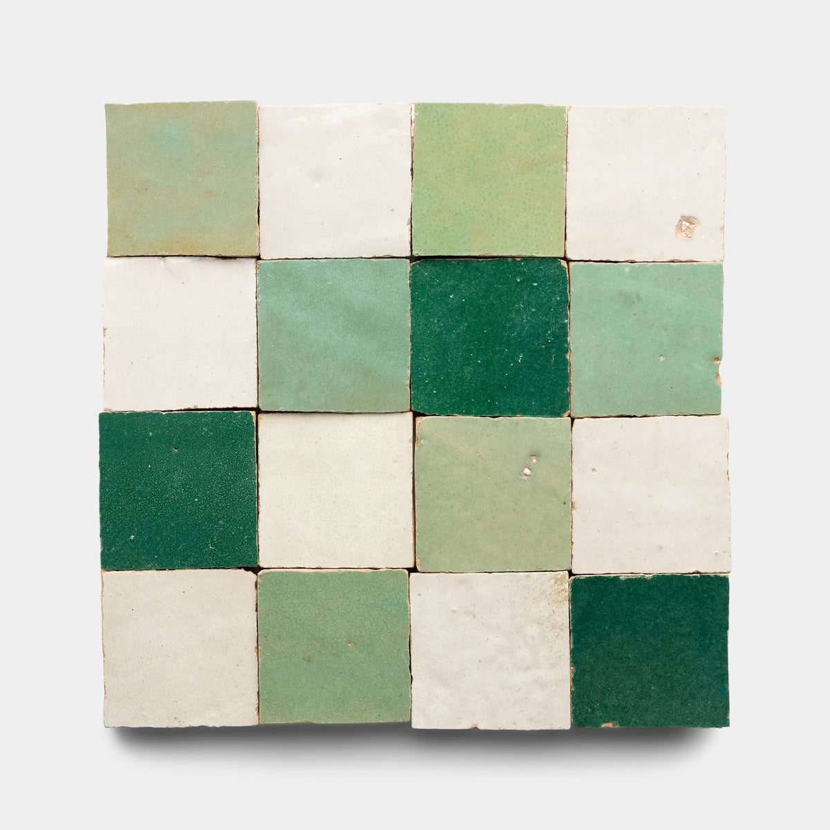 The Tidepool + Casablanca + Jade Checkerboard Sample by Zia Tile is a 4x4 square panel of 16 handmade tiles with alternating green and white shades in glossy and matte finishes, forming a textured, checkered pattern.