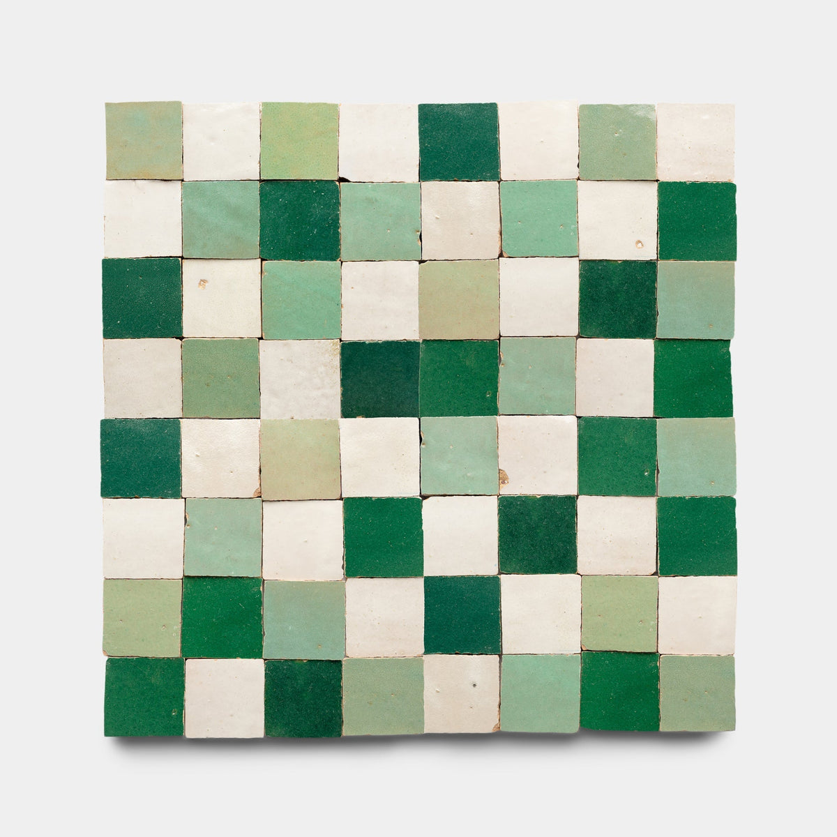 A close-up of the Tidepool + Casablanca + Jade Checkerboard sample showcases the detailed patterns and textures that exemplify Zia Tile’s artisanal cement tile craftsmanship.