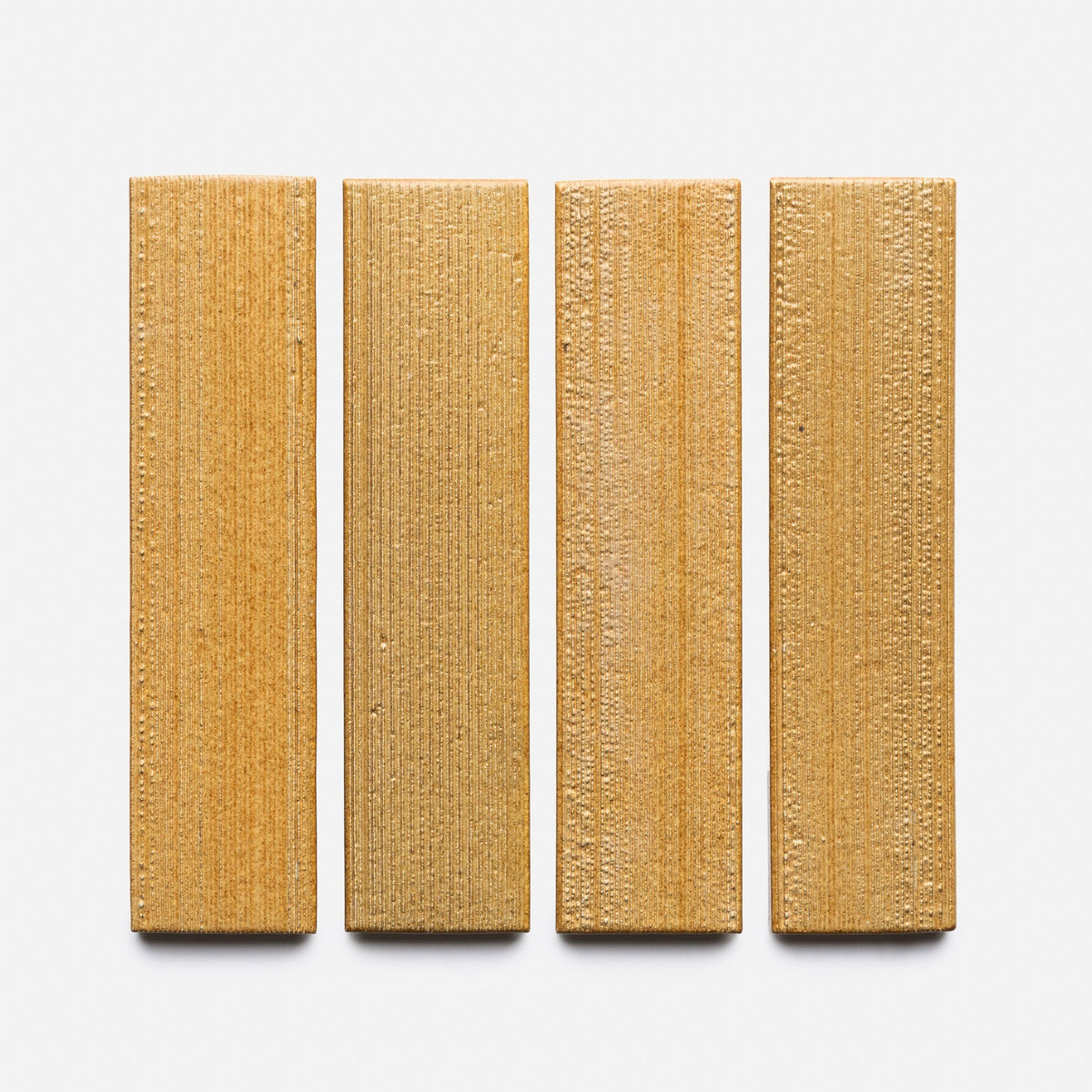 A row of Toast + Etched, Sample wood planks by Zia Tile.