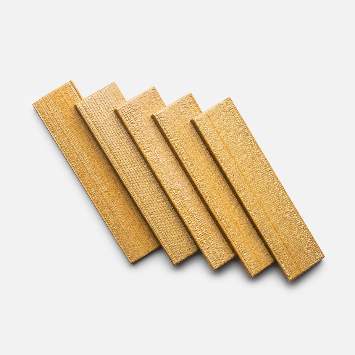 Five rectangular Toast + Etched wood samples by Zia Tile are arranged in a slightly fanned-out, overlapping pattern on a white background.