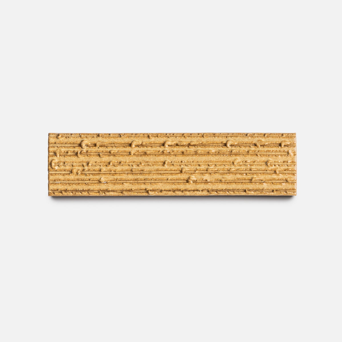 A rectangular, light brown Toast + Furrowed, Sample tile by Zia Tile with textured horizontal ridges, displayed against a plain white background.