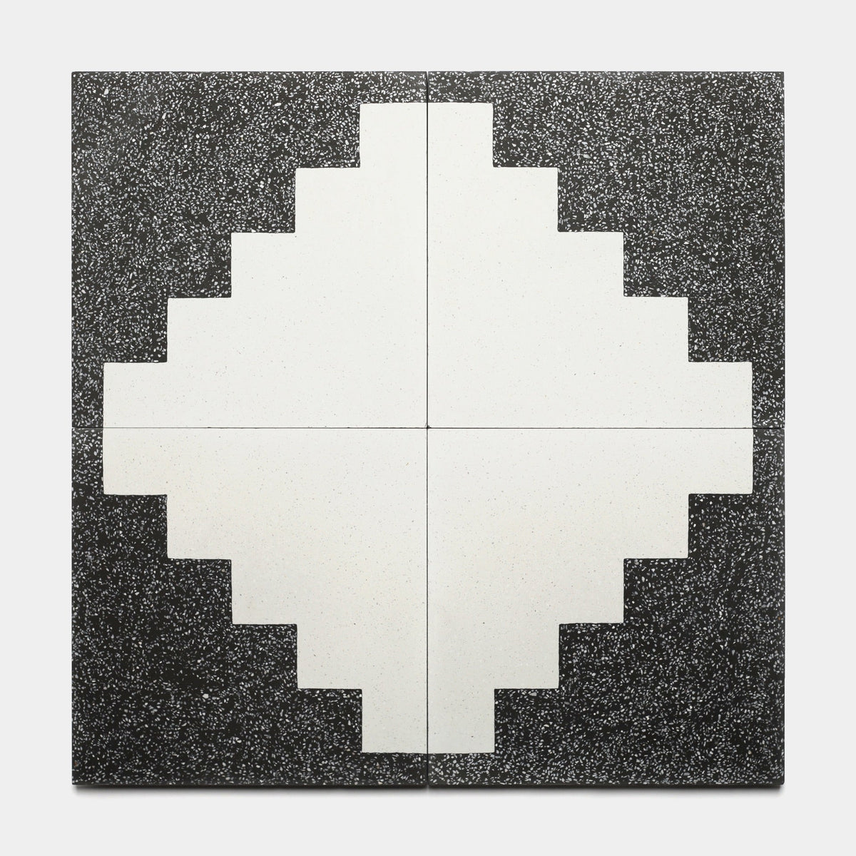 A geometric artwork made from four Zia Tile Trellick Ash 12x12 samples forms a stepped-edge white diamond at the center, aligned over a black speckled background.