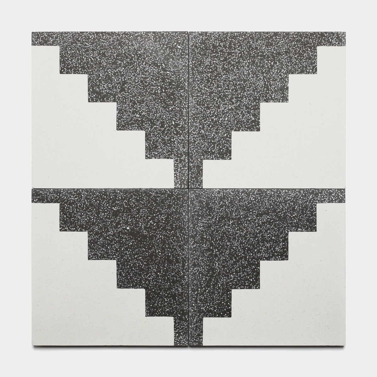 Four Trellick Ash 12x12 samples by Zia Tile are arranged in a grid with black and white stair-step patterns, forming a symmetrical design where black corners meet at the center—ideal for showcasing this striking tile style.
