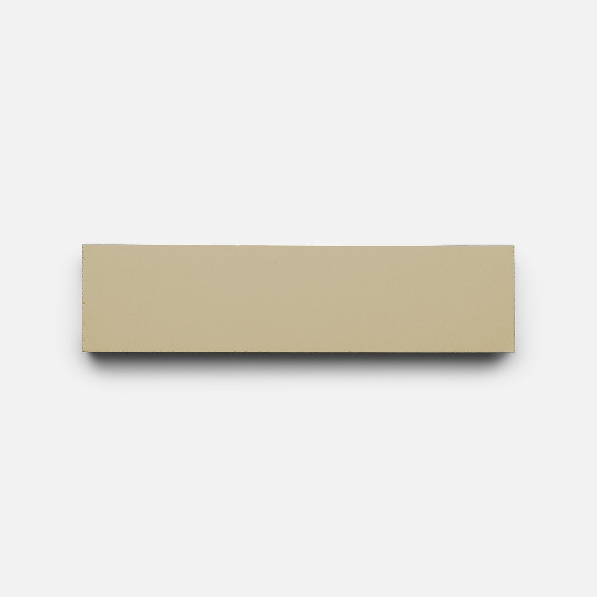 A Truffle 2x8 tile sample by Zia Tile, rectangular and beige, is displayed horizontally against a plain white background.