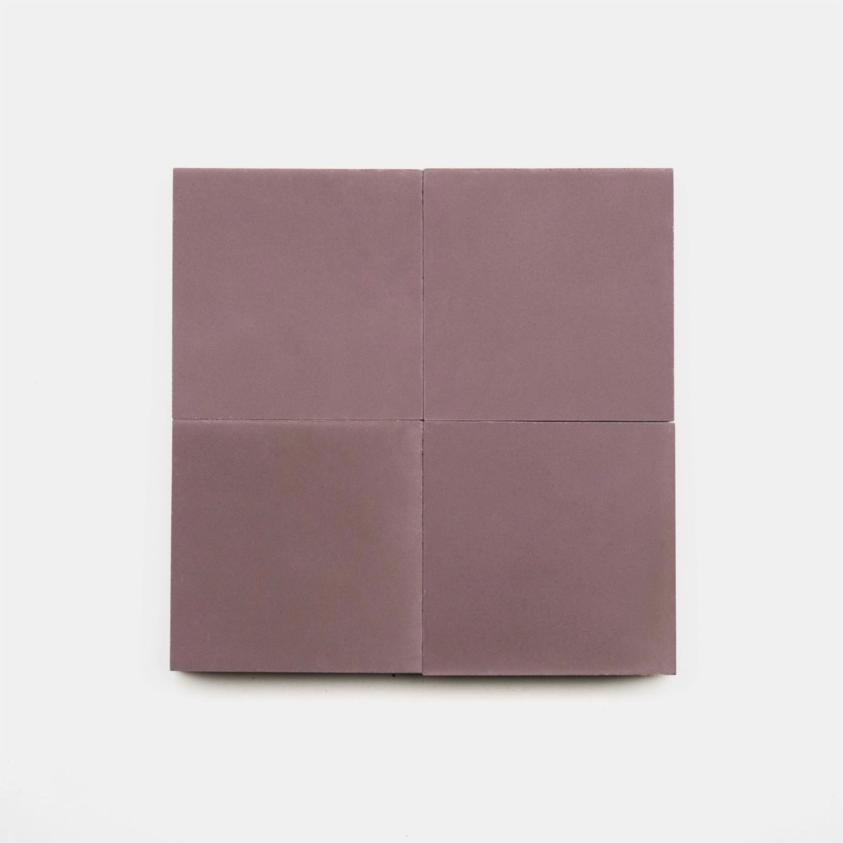Four square Tyrian 4x4 cement tiles, mauve-colored and handmade by vendor-unknown, are arranged in a larger square shape on a plain white background.