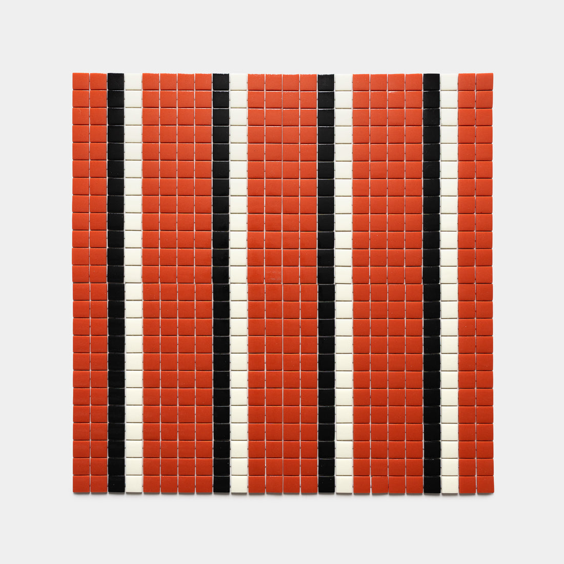The Union Roma + Jet Black + Milk by Zia Tile features a square grid of small red tiles, each with three evenly spaced vertical stripes—black and white lines—set against a white background.