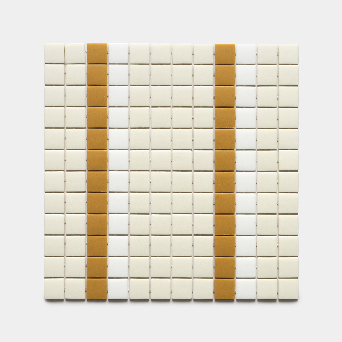 A grid of small, square Union Milk + Rye + Paperwhite tiles by Zia Tile features two vertical columns of mustard-yellow tiles on an off-white background.
