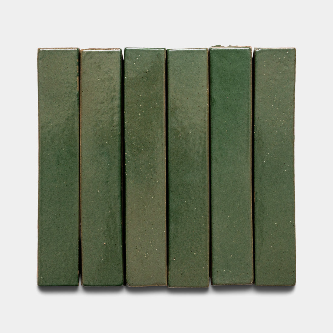 Six Valverde Mini Bar tiles from Zia Tile are arranged vertically side by side against a white background. The rectangular green tiles have a glossy, slightly speckled surface.