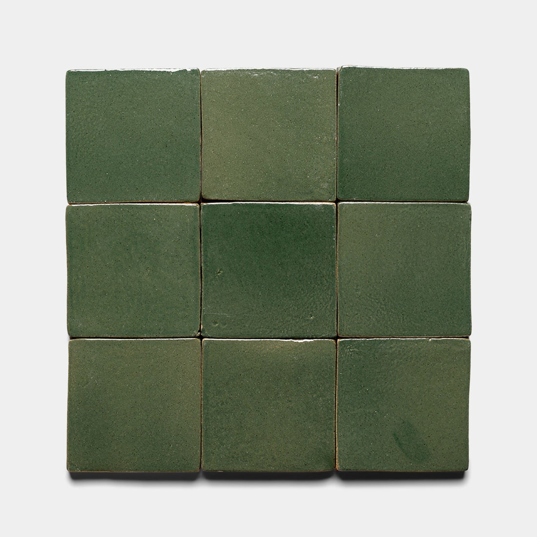 Nine Valverde 4x4 Square tiles by Zia Tile are arranged in a 3x3 grid on a white background. Each green tile features subtle shade and texture variations for an authentic, handcrafted look.