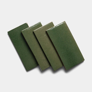 Four Valverde 4x8 Rectangle tiles by Zia Tile are arranged in a slightly overlapping, diagonal row on a white background, casting soft shadows.