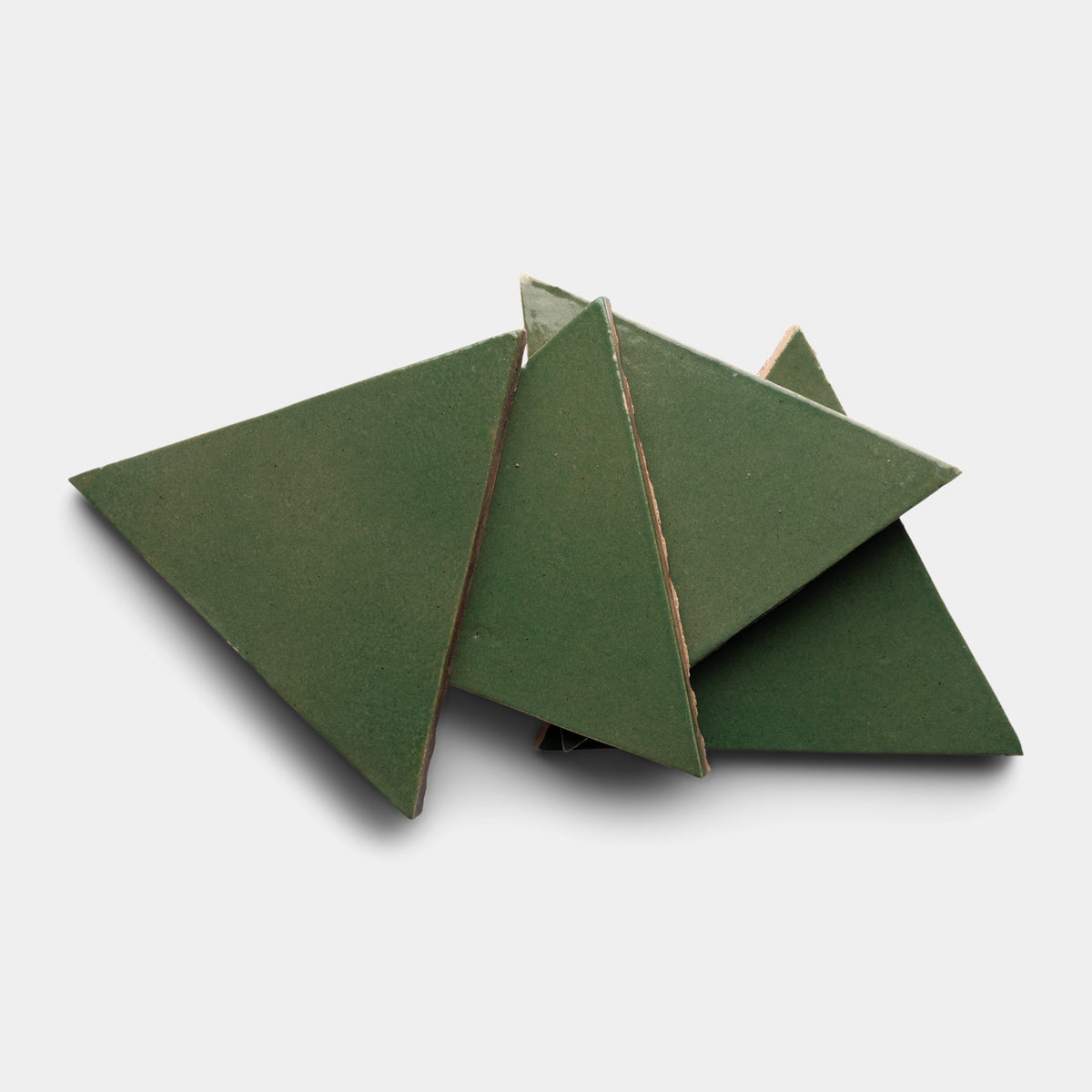 Five Valverde Triangle tiles by Zia Tile, in green ceramic, are arranged overlapping on a plain white background.
