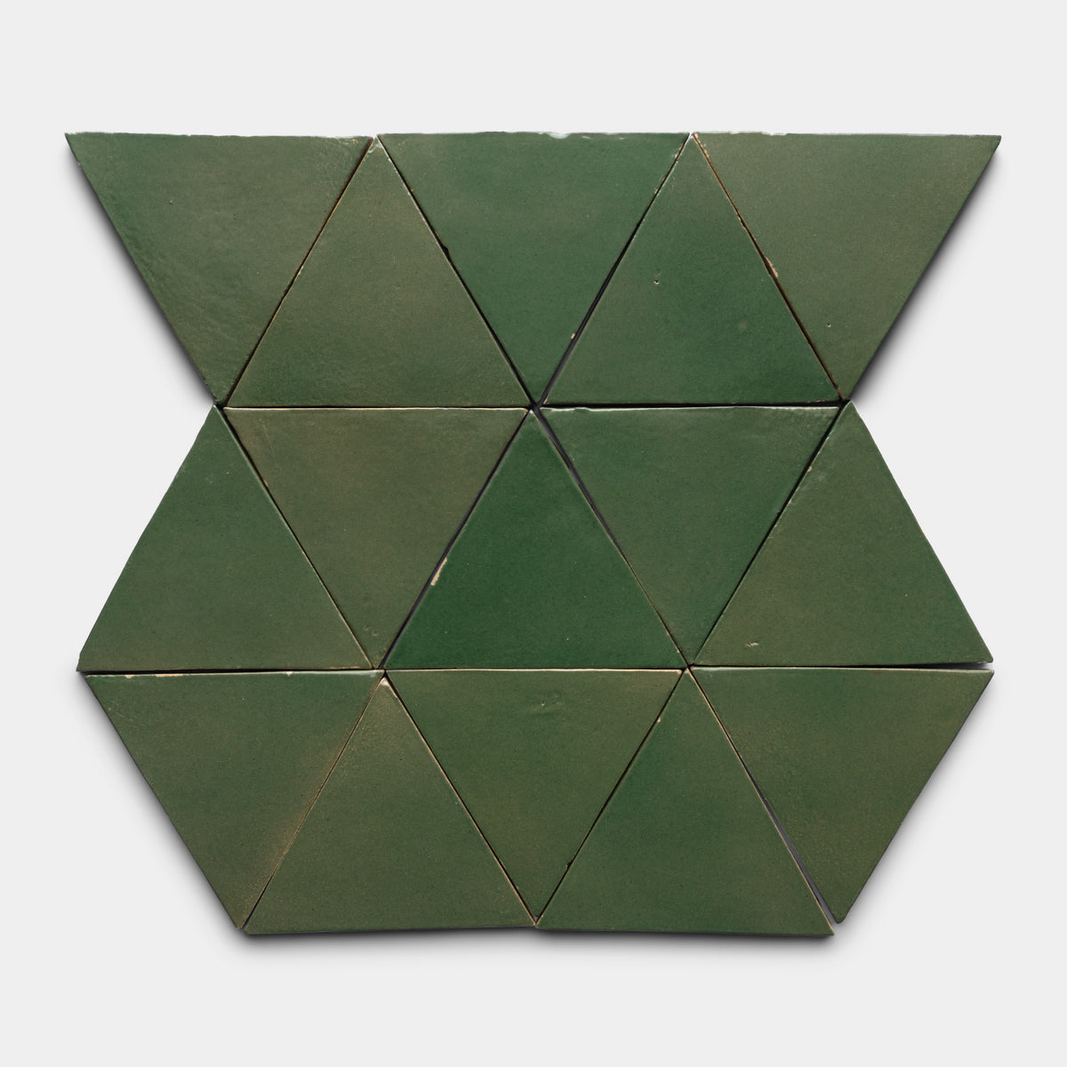 The Valverde Triangle by Zia Tile features ten green ceramic triangles arranged symmetrically on a white background. Six form a central hexagon, while two each are positioned above and below the main design.