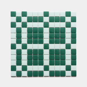 The Vaso Jasper + Piscine tile sample from Zia Tile features a grid of square tiles in alternating green and white, creating a bold geometric stripe pattern.