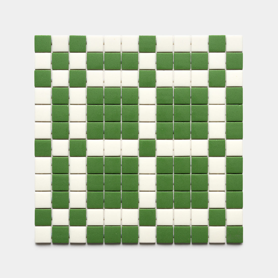 The Zia Tile Vaso Clover + Milk sample features a rectangular grid of small square tiles in green and white rows, forming a symmetrical geometric pattern on a light background.