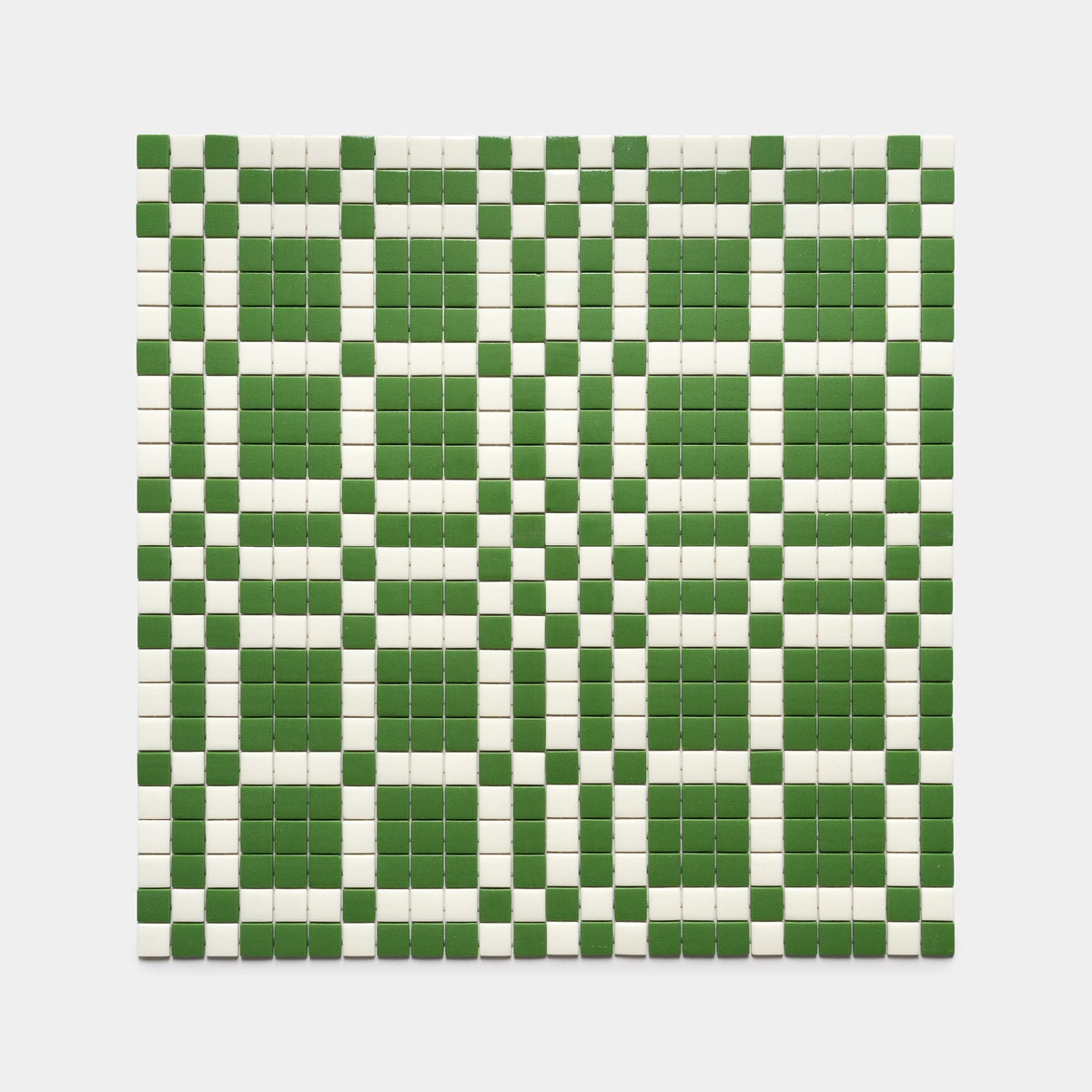 The Vaso Clover + Milk by Zia Tile features a grid of small square tiles in alternating green and white, creating a striking checkered geometric pattern against a white background.