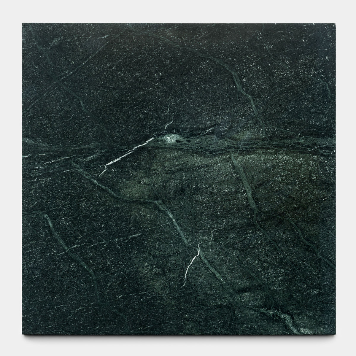 The Verde Alpi 24x24 slab from Zia Tile features a dark green surface with subtle white and light green veins, capturing the natural elegance and handmade aesthetic of the brand’s signature collections.