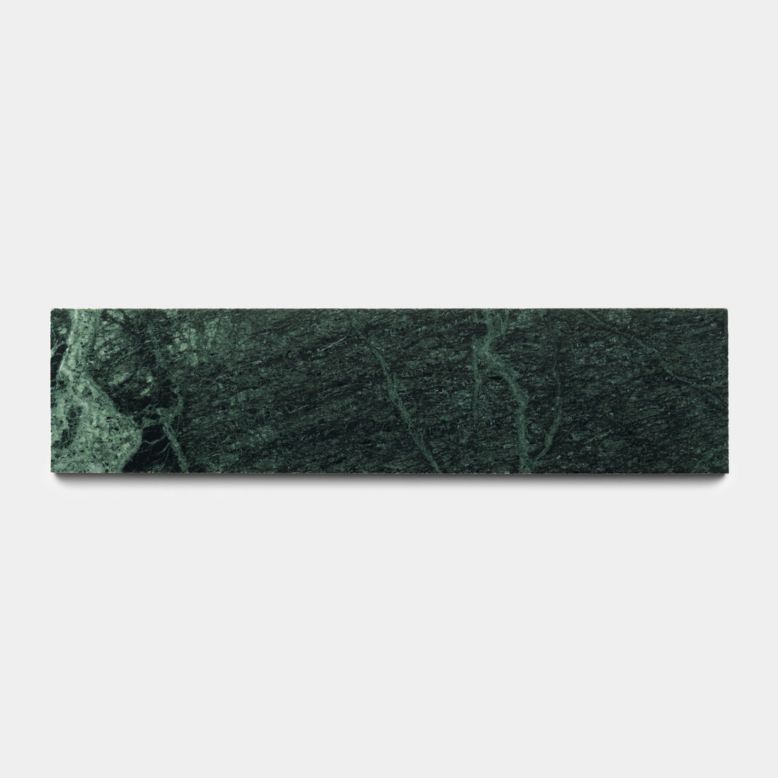 The Verde Alpi 3x12 by Zia Tile is a rectangular dark green marble tile with lighter green veins, displayed on a plain white background.
